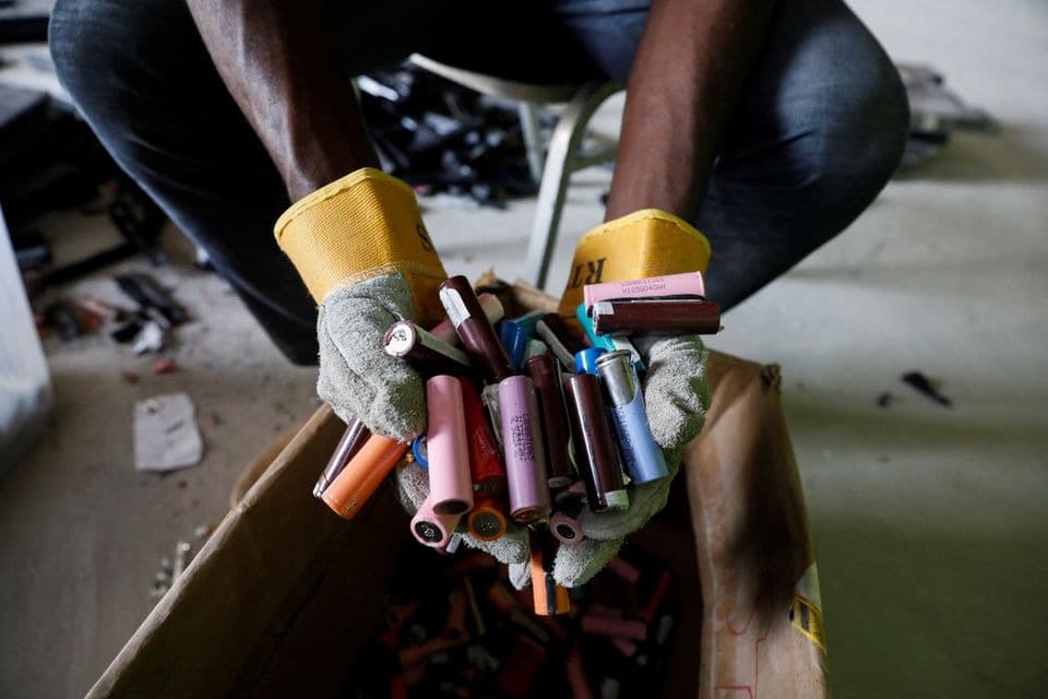 Recovered lithium-ion cells being handled for assessment at a Quadloop workshop.